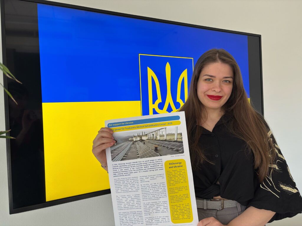 A volunteer holding a leaflet about EKOenergy's support to Ukraine